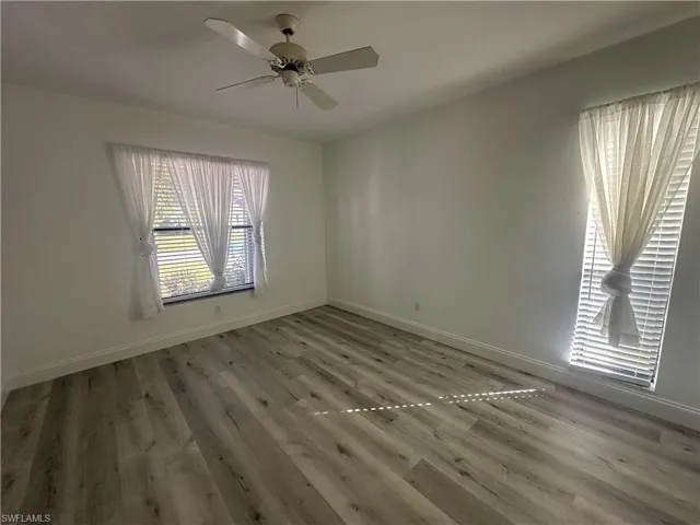 Spare room with light wood-type flooring and ceiling fan