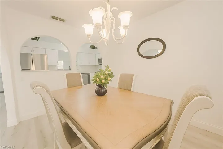 Dining space with a chandelier and light wood finished floors