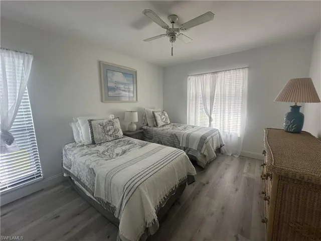 Bedroom featuring wood finished floors and a ceiling fan