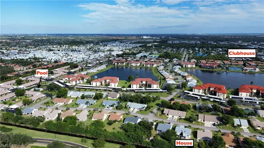 Aerial view of property's location with a nearby body of water and nearby suburban area