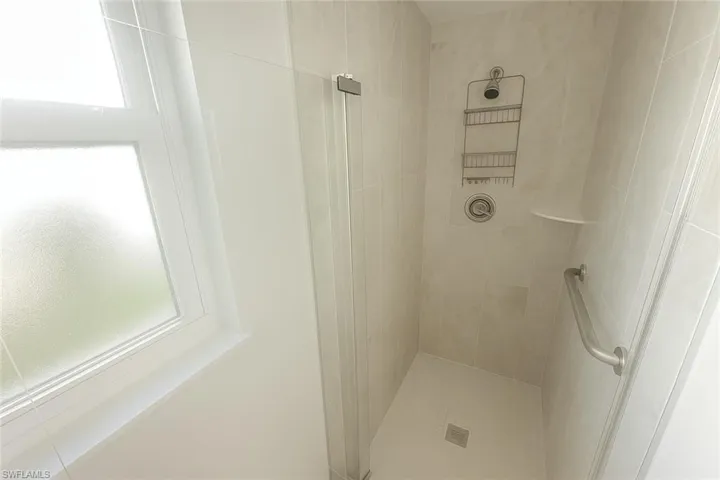 Full bath with plenty of natural light and a shower stall