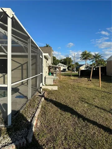 Rear view of house with a patio, a lanai, a sunroom, and an outdoor pool