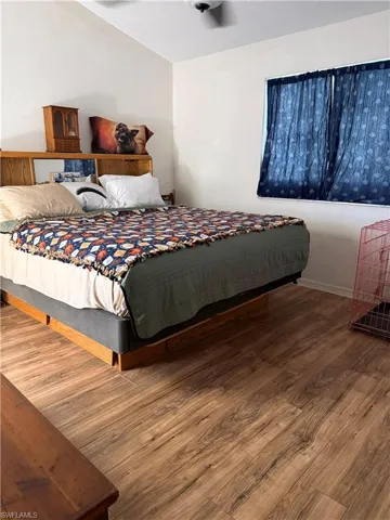 Bedroom with wood finished floors and ceiling fan