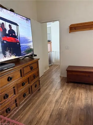 Bedroom featuring wood finished floors, a textured ceiling, and ceiling fan