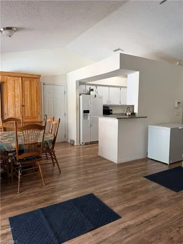 Dining space featuring wood finished floors and a textured ceiling
