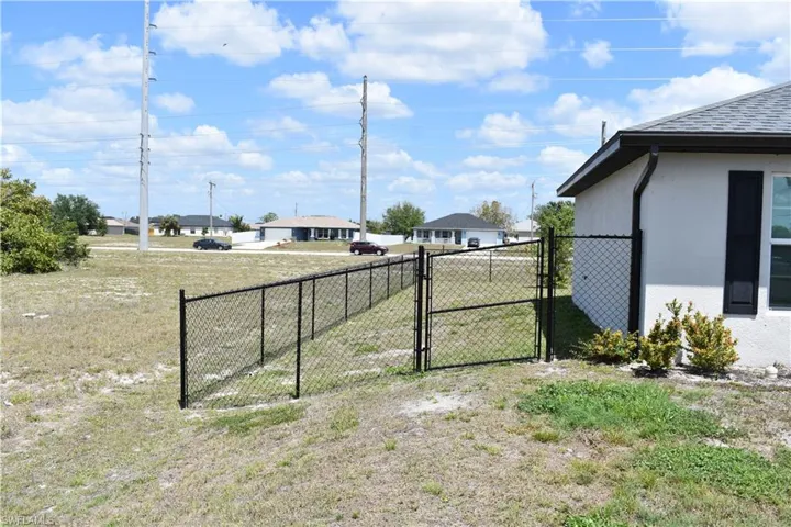 View of yard with a gate and fence