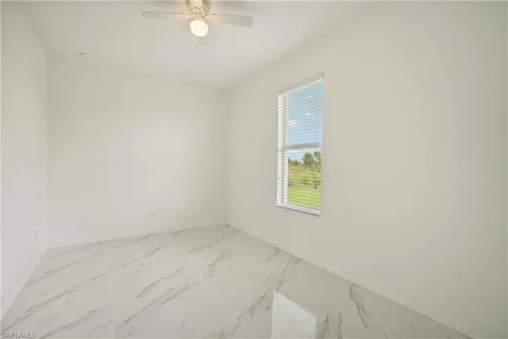Spare room with ceiling fan
