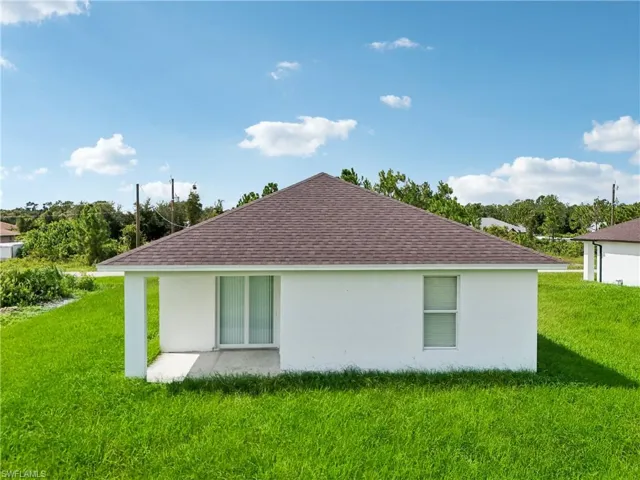 View of side of home featuring a lawn