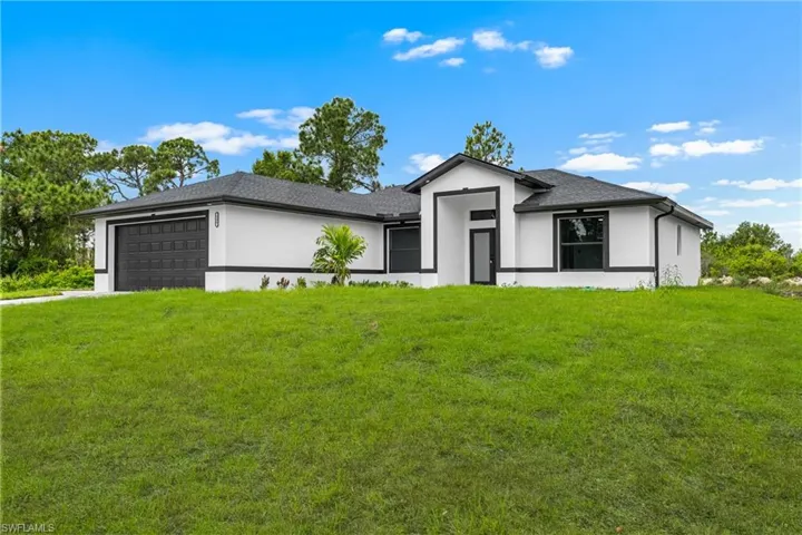Contemporary exterior featuring white stucco and dark trim accents