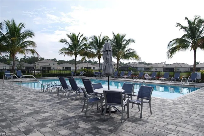 Community pool with a patio and a residential view