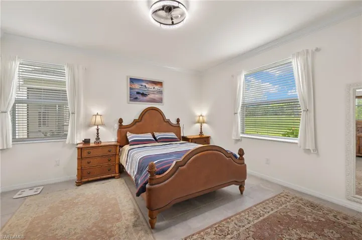 Tiled bedroom featuring baseboards and ornamental molding