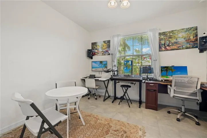 Office area with lofted ceiling and baseboards