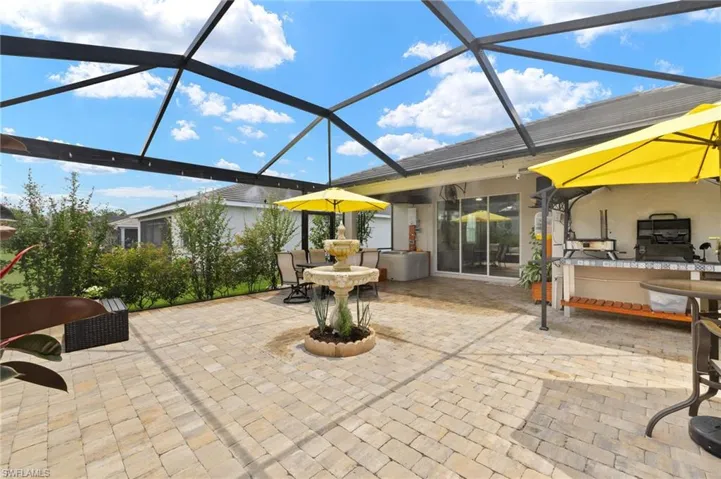 View of patio / terrace featuring glass enclosure and exterior bar