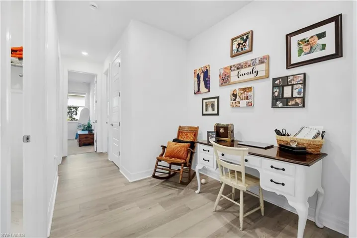Neutral interior featuring light-toned wood-finish flooring, recessed lighting, and multi-panel interior doors