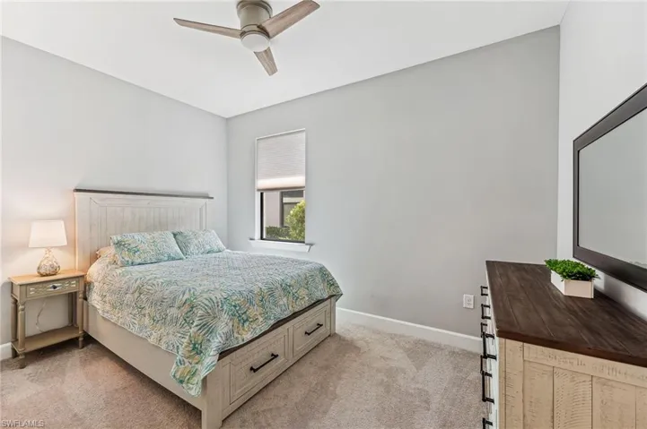 Bedroom featuring light colored carpet and ceiling fan