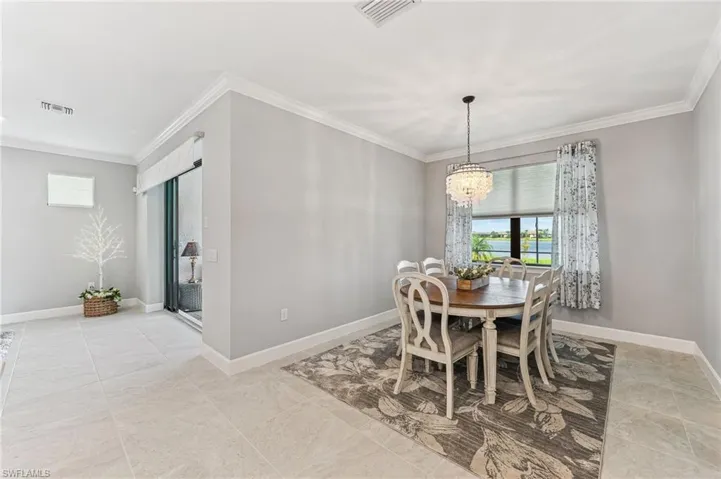 Dining area with a chandelier and ornamental molding