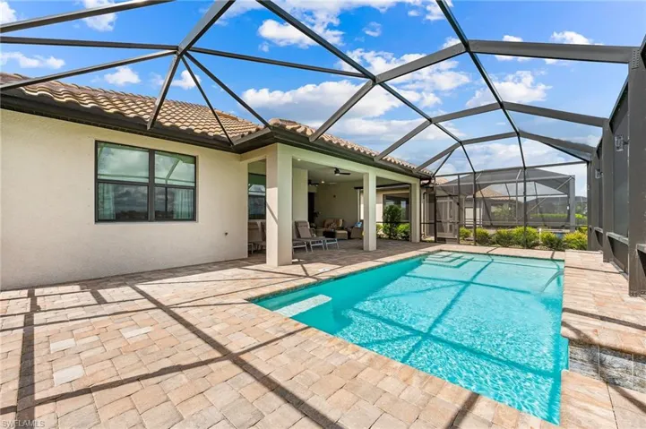 View of pool featuring ceiling fan, a lanai, and a patio