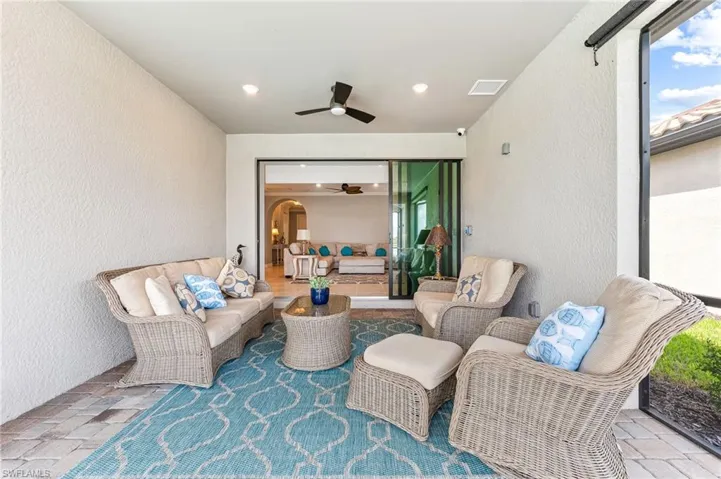 View of patio featuring an outdoor living space and ceiling fan