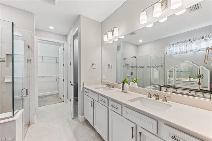 Bathroom with a shower with door and vanity