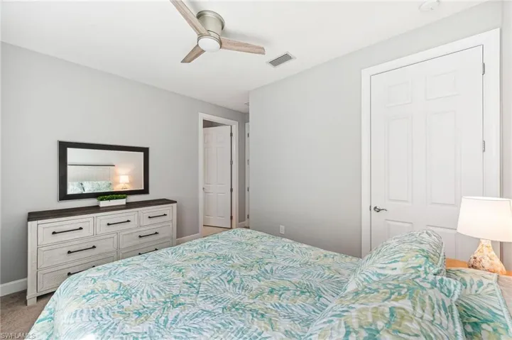 Carpeted bedroom with ceiling fan