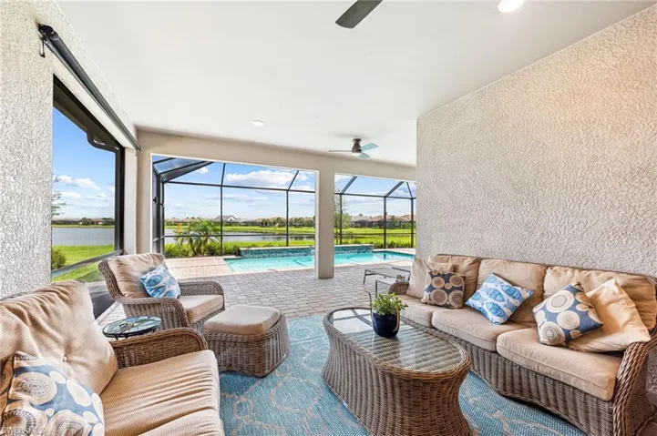 View of patio / terrace featuring glass enclosure, ceiling fan, and an outdoor hangout area