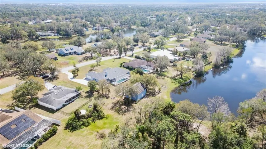 Birds eye view of property featuring a water view and a residential view