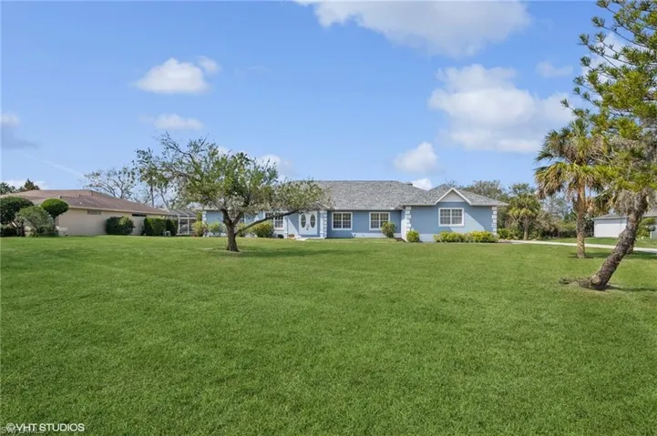 Ranch-style home featuring a front yard