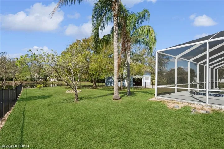 View of yard featuring a lanai, a fenced backyard, and a patio