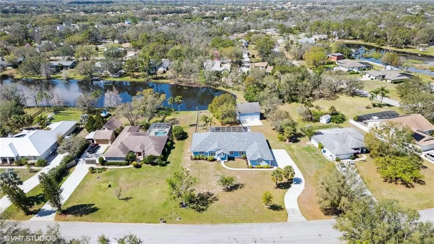 Birds eye view of property featuring a water view and a residential view