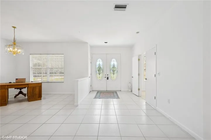 Foyer featuring a wealth of natural light, visible vents, and light tile patterned floors
