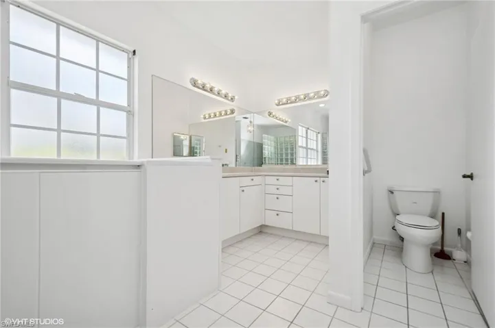 Bathroom featuring vanity, toilet, and tile patterned floors