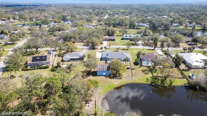 Birds eye view of property with a residential view and a water view