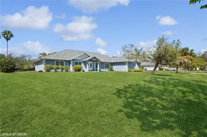 Ranch-style house featuring a front lawn