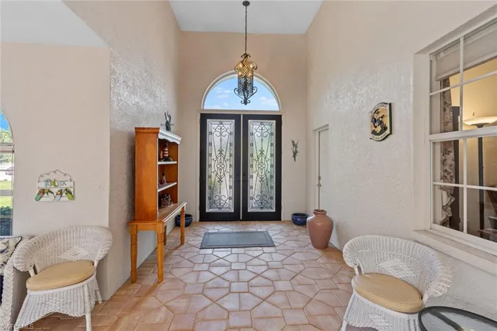 Entrance foyer featuring french doors and a textured wall