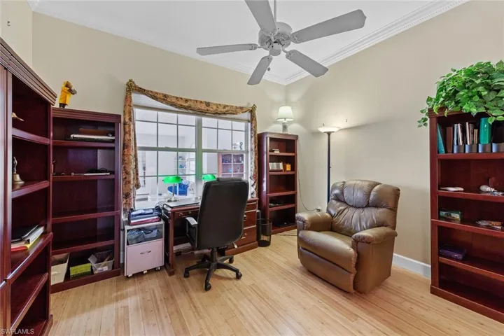 Office space featuring crown molding, wood finished floors, and ceiling fan