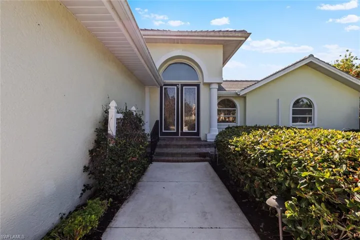 Entrance to property with stucco siding