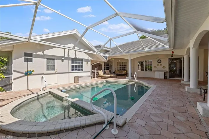 View of swimming pool with an outdoor hangout area, a pool with connected hot tub, and a patio area