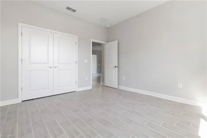 Unfurnished bedroom featuring light hardwood / wood-style flooring and a closet