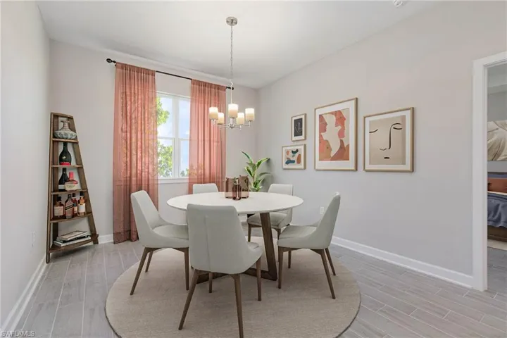 Dining room featuring light hardwood / wood-style floors and a notable chandelier