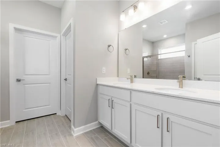 Bathroom with a shower with door and vanity