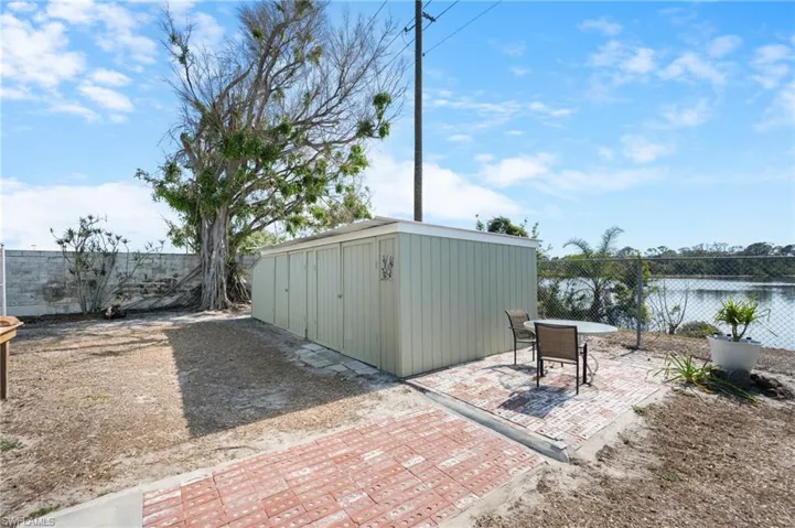 Fenced backyard with a patio area and a shed