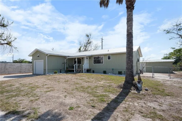 View of front of property with a garage, driveway, and crawl space