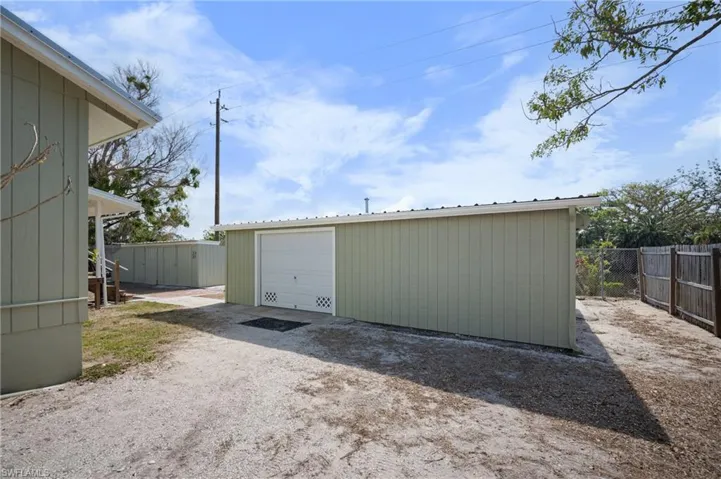 Detached garage with dirt driveway
