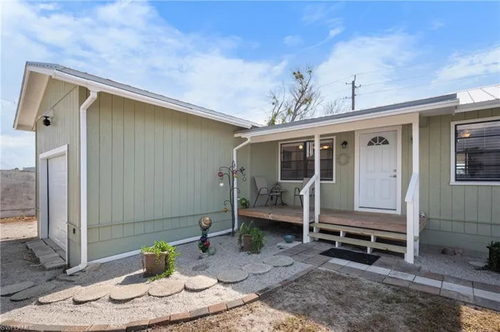 View of front of house featuring a garage and a porch