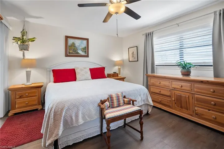 Bedroom with dark wood-style flooring and ceiling fan