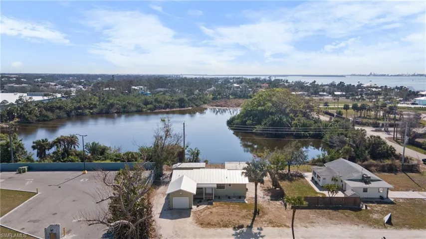 Aerial view of property and surrounding area featuring a large body of water
