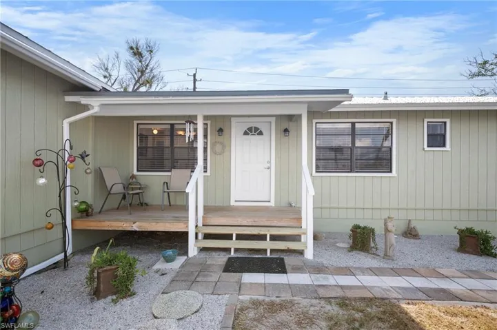 Doorway to property featuring a porch