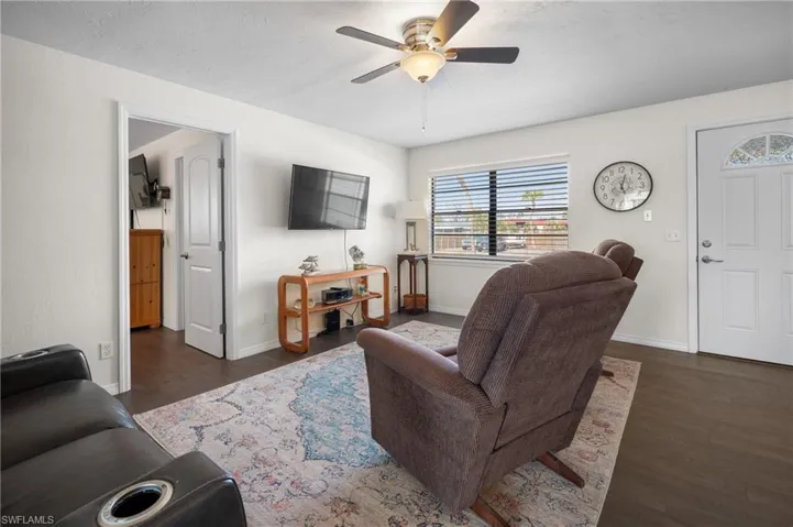 Living room featuring wood finished floors and a ceiling fan