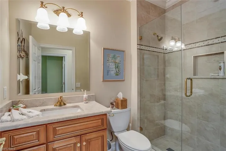 Guest bathroom is full sized and updated featuring a shower stall and vanity