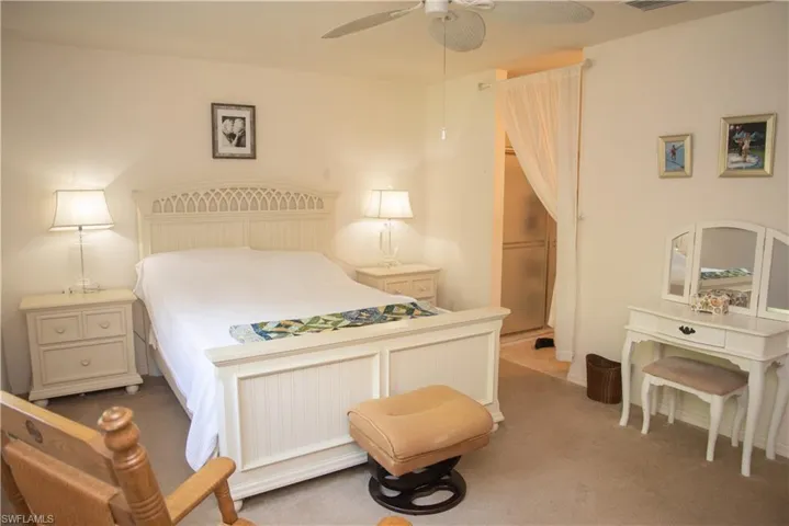 Bedroom with ceiling fan and carpet flooring
